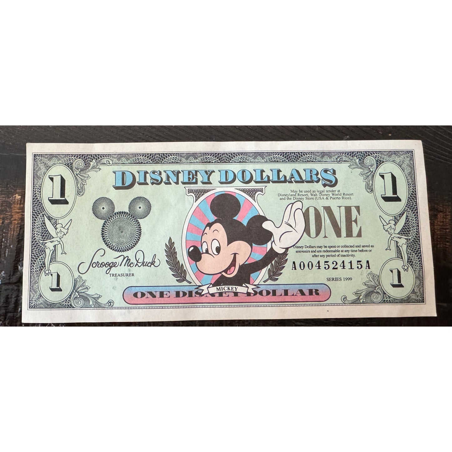 Disney Dollar Mickey 1999 $1 1 dollars serial number. A00452415A.  No folds or tares.  front feature is Mickey Mouse and the back features Cinderella castle.