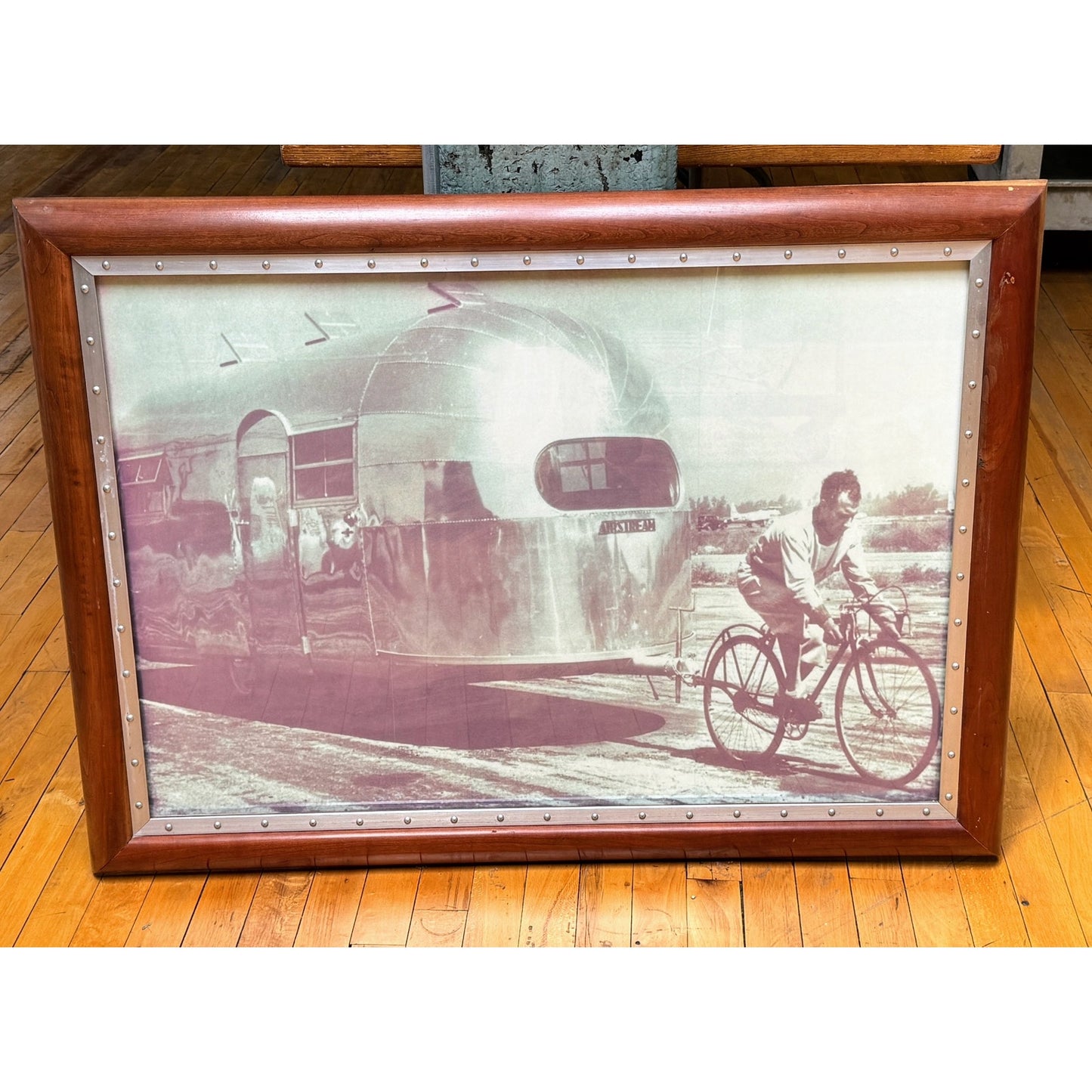 Vintage Airstream Black and White Framed Photo of man pulling Airstream with bicycle